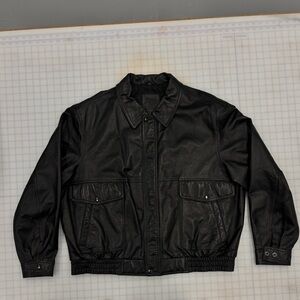 Oversized black leather bomber jacket